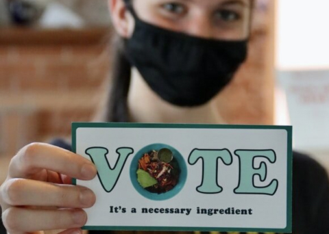 Woman holding vote card