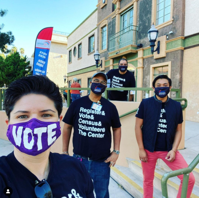 People with vote masks and tshirts