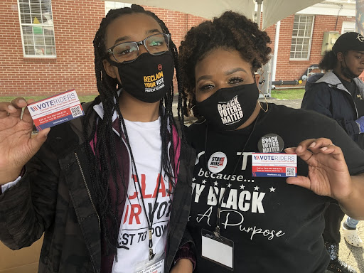 women in Florida with Vote Riders cards