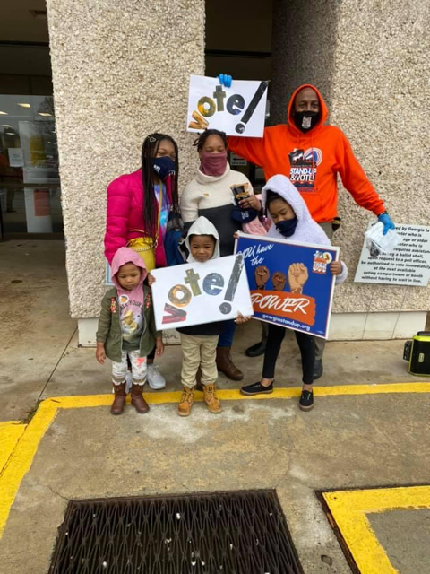 Family with Vote sign