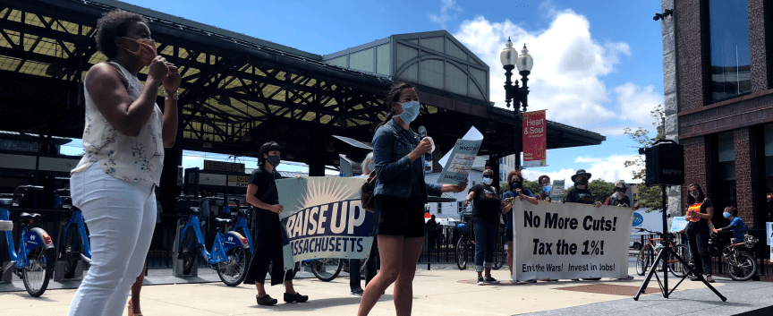 Protestors with signs Raise Up Massachusetts