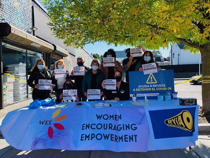 Group behind a table for Women Encouraging Empowerment