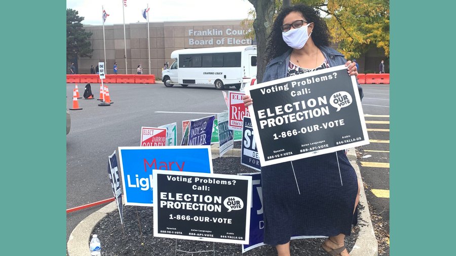 Woman holding election protection sign in Ohio