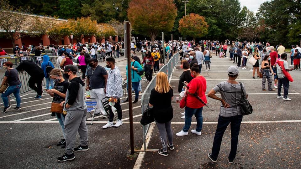 Georgia voters practice social distancing while waiting to vote.