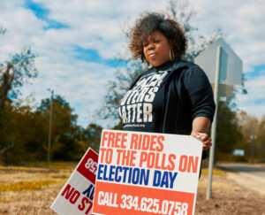 woman with a sign for free rides to the polls on election day