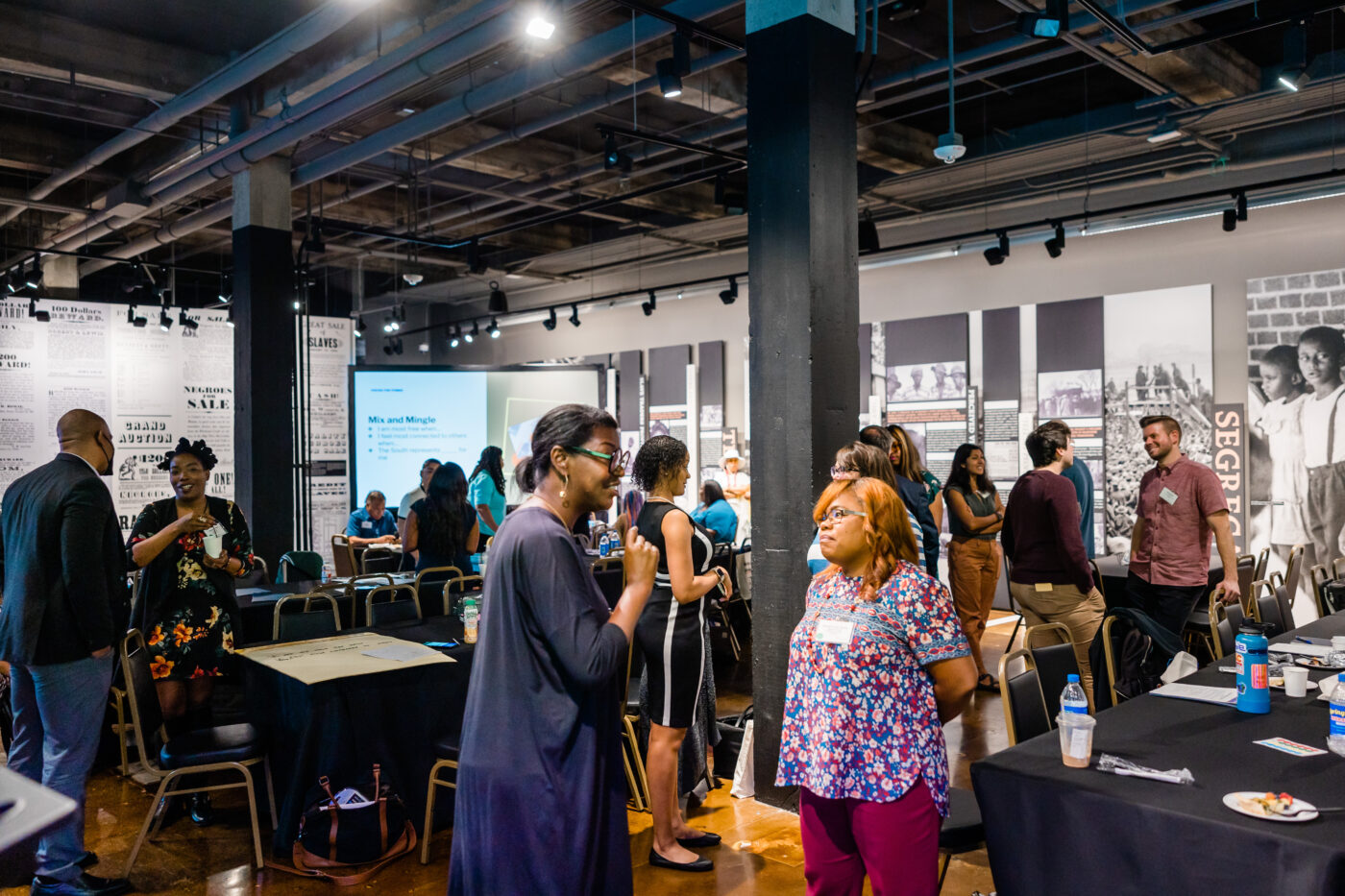 Attendees openly conversing at The Legacy Museum