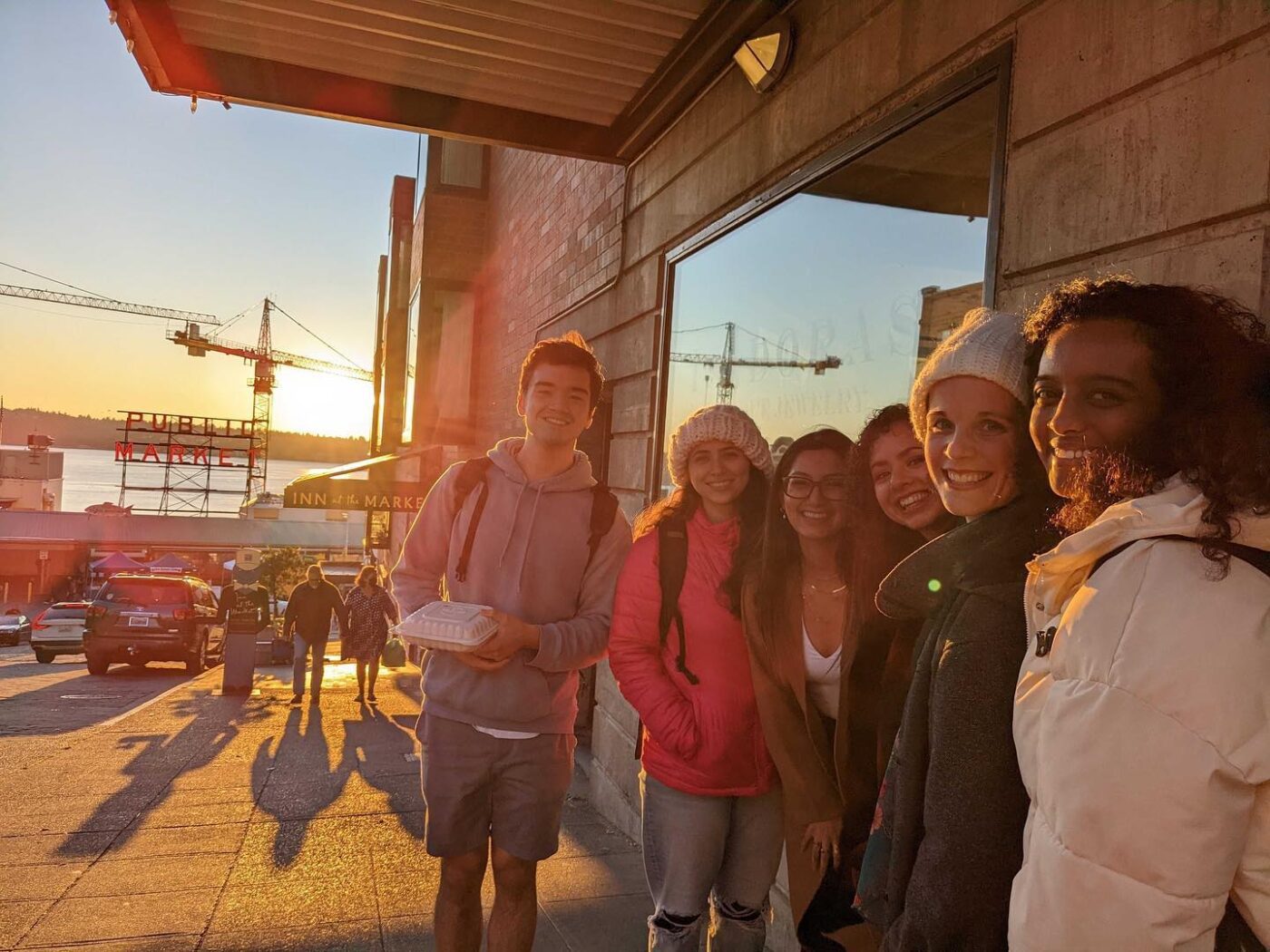group of young people standing outside the public market