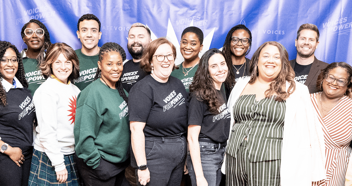 group of people wearing voices for power tshirts